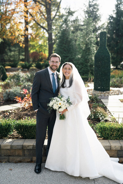 Bride and groom smiling outdoors during their late fall intimate wedding in Cleveland, Ohio.
