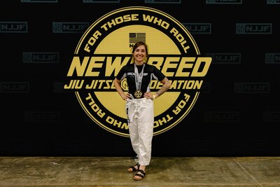 Photo of Caity Melo at a jiu jitsu competition 