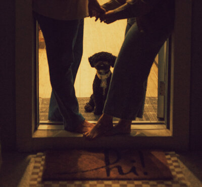A couple holds hand at the entrance to their new home in North Georgia.