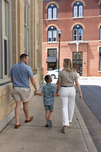 Amanda, husband, son walking away from camera