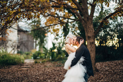 Groom pulling his bride in for a kiss on the San Antonio Riverwalk.