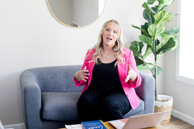 Becca sitting on a couch speaking to a consulting client from across the room