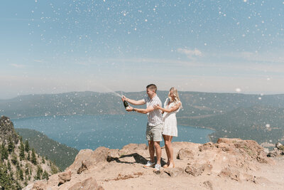 newly engaged couple popping champagne