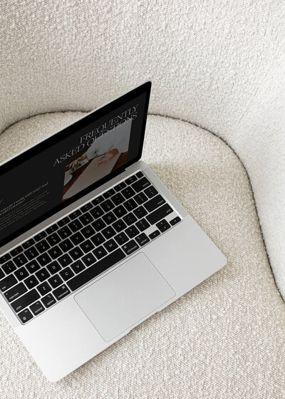 Two female business owners working on laptop and making notes