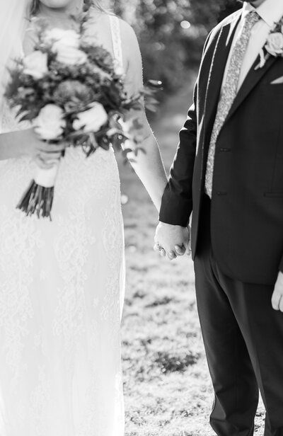 bride and groom kissing while under veil