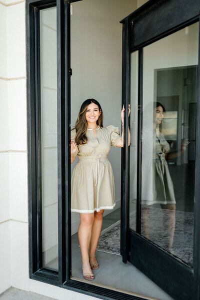 Melony Berg, a realtor at Capital Realty, posing confidently in  her home.