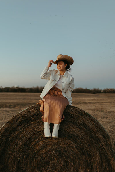 High school senior poses in the country with Ashley Cole Photography