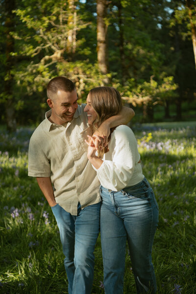 Couple dancing in a flower field looking at each other 