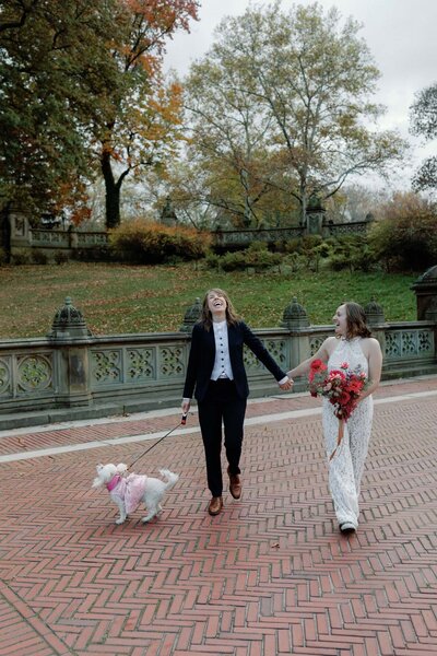 central park elopement fall couple with bridal jumpsuit walking with dog