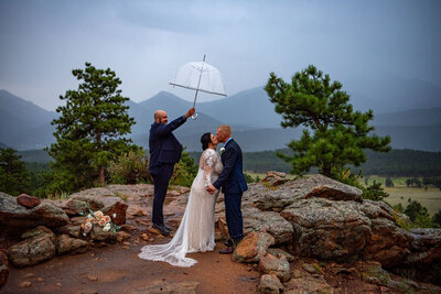 Bride and Groom laugh at a joke the groom made at the overlook to an alpine lake.