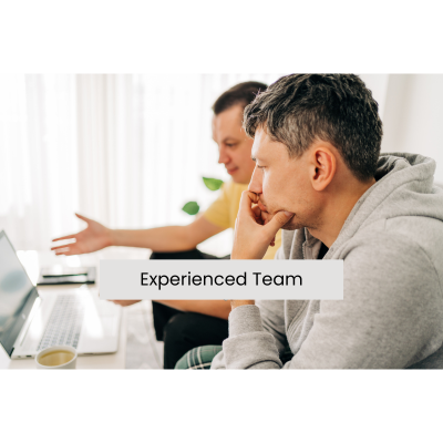 Two team members reviewing a project on a computer monitor with the words “Experienced Team” written across the image.