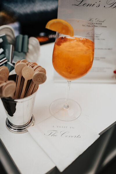 bride and groom hugging and smiling while she is holding a bouquet