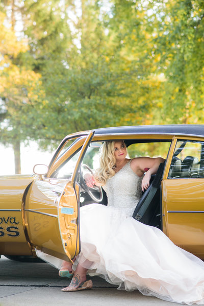 Bride in her vintage mustard yellow convertible