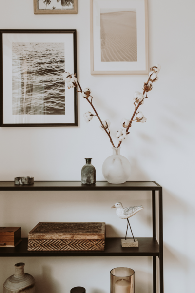 entryway table with decor and wall of photos