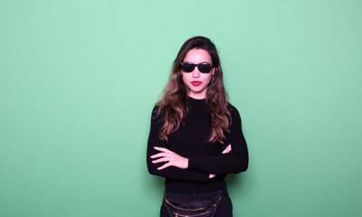 woman standing front of a green screen