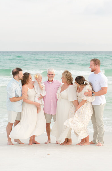 Three generations enjoying a light-filled beach portrait session in Destin, FL captured by Andrea Krey Photography