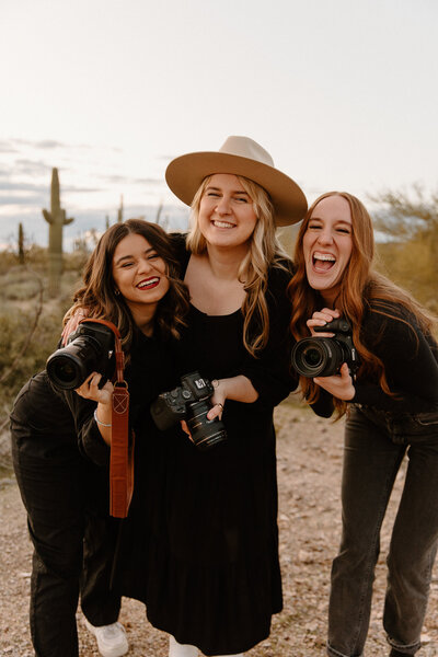 Lead photographer and her associate shooters. Canon cameras. Wedding photographers.