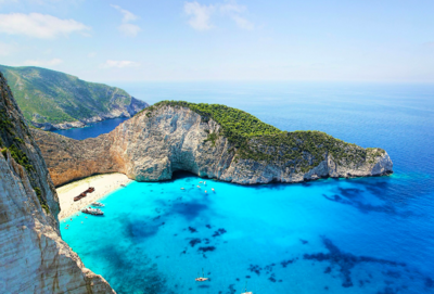Breathtaking cliffside beach in Greece with turquoise waters, ideal for luxury travel and Mediterranean escapes.