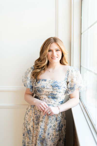 New England-based destination wedding photographer, captured in a soft floral dress. Felisha is known for her heartfelt and authentic approach to capturing love stories, preserving timeless moments at weddings across Boston, Rhode Island, New England, and worldwide locations.