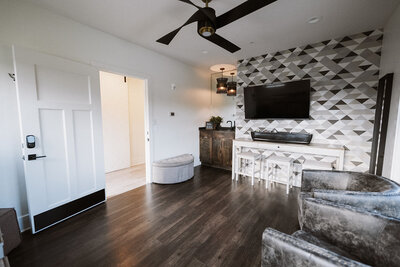 Groom Suite with patterned wallpaper, soft seating,
