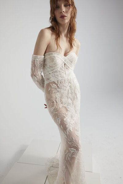 black and white image bride wearing feathered wedding dress