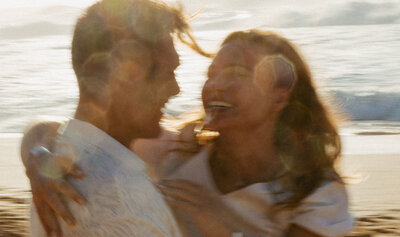 couple embracing and laughing on melbourne beach