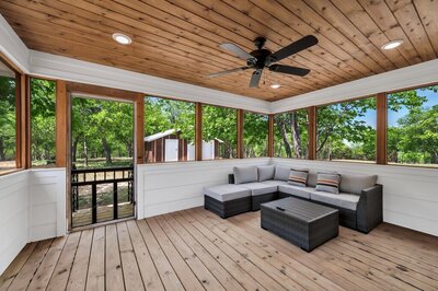 Enjoy lovely views on this screened in back porch of this three-bedroom, two-bathroom rental farmhouse near Lake Waco, golf courses, and 15 minutes to downtown Waco & Baylor.