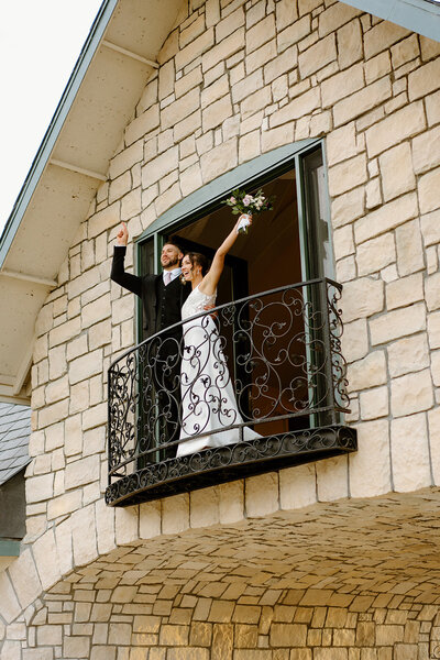 bride and groom standing outside of venue
