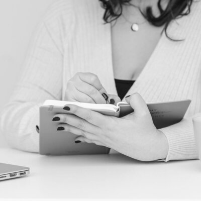 Woman with dark hair holding ipad for high end branding services
