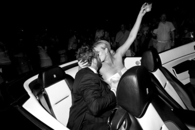 West Palm Beach wedding photographer, Priscila Del Cristo, capturing a couple leaving their wedding in a classic vintage car. 