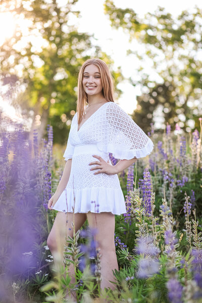 Girl in white dress in Lupin field | Senior Session with Maine Photographer