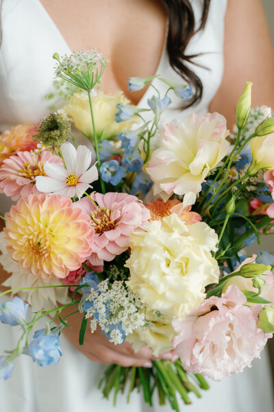 Classic bridal bouquet showcasing white hydrangeas, roses, and touches of greenery, expertly crafted by Leigh Florist for a timeless wedding look.