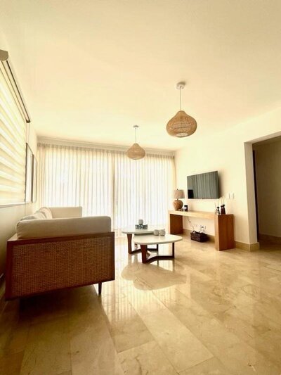 Bright living room with woven pendant lights and sleek furnishings in a luxury villa