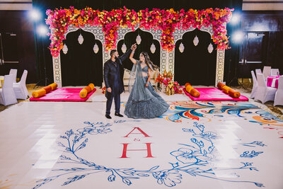 Indian sikh groom twirling the bride at the sangeet jaago wedding event in a decorated ballroom