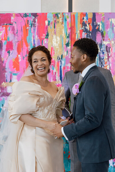 bride and groom sit and smile at each other in Chicago