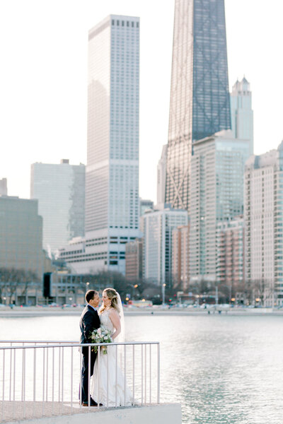 bride and groom in Olive parck with the view to the Chicago skyline