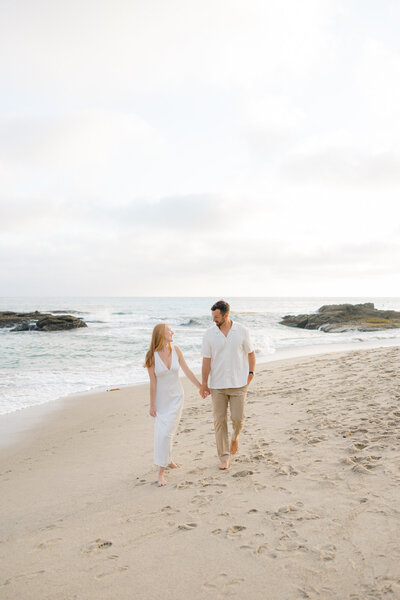couple walking hand in hand on the beach