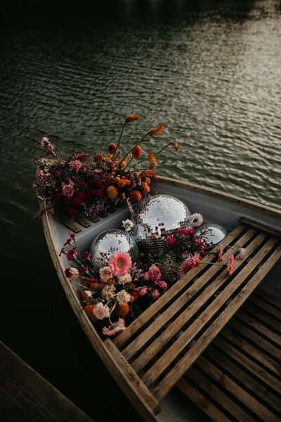 Disco Balls and flowers in a ow boat at Hadsham Farm. 