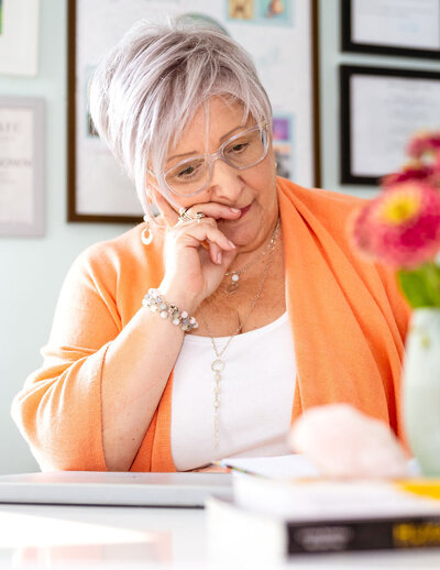 April Goff Brown sitting at her desk reflecting and journaling
