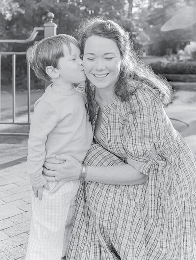 Timeless black and white portrait of a mother and son, capturing a sweet kiss and heartfelt connection—photographed by a Birmingham, AL family photographer