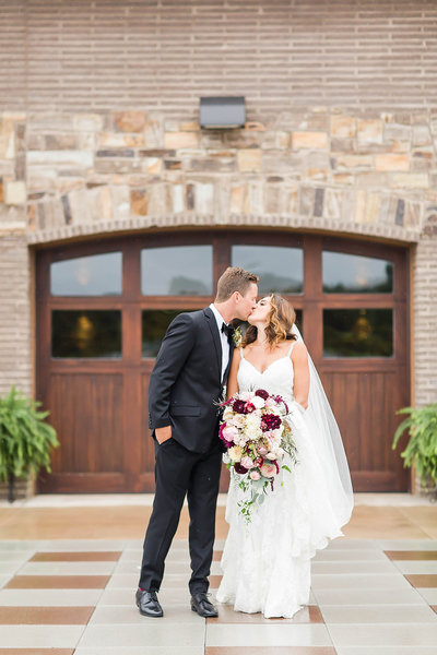 textured wedding bouquet with greens, whites, and purples at oaks lakeside wedding