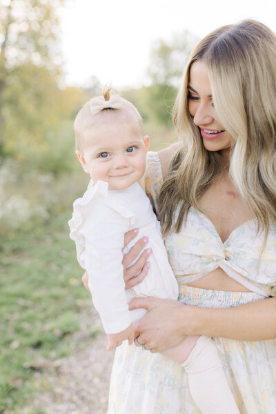 Expecting mother in father standing in Wisconsin field