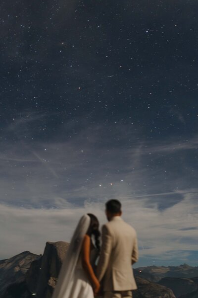 couple walking beach cliffs