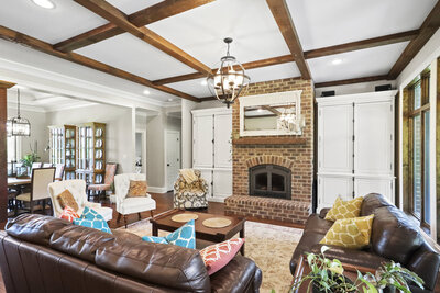 living room with brick fireplace and leather couch