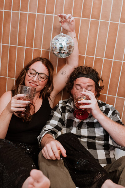 Couple partying in a bathtub with champagne and a disco ball in Breckenridge, Colorado.