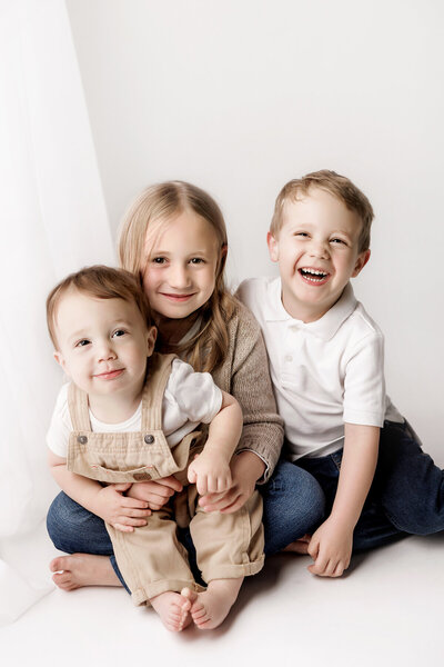 Fort Collins newborn girl wrapped up with 3 bows tied in