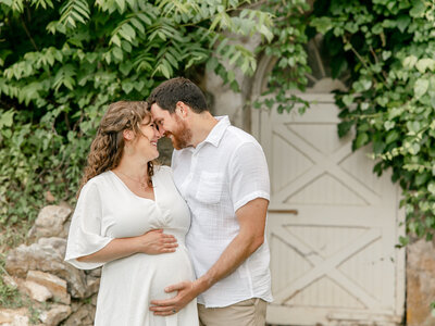 Happy could embracing while holding the pregnant belly of the mom
