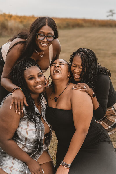 A joyful group of friends enjoying a portrait session in Urbana, IL. Light By Zoey Photography captures fun and authentic moments for friends and families in Champaign-Urbana and Mahomet, IL.