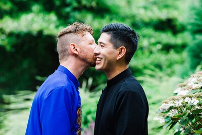 LGBTQ Couple in traditional Vietnamese ao dai kissing cheek