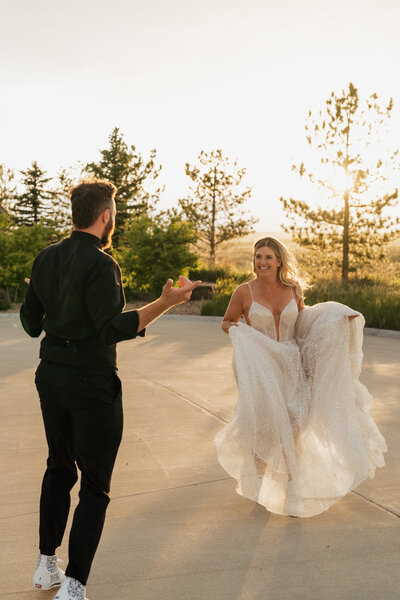 Bride laughing and running towards groom